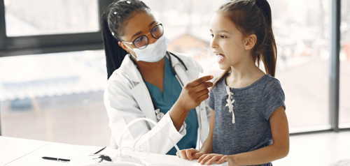 Allied health professional providing early intervention support to a child at Gosford Doctors