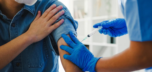 Nurse administering a seasonal flu vaccine at Gosford Doctors